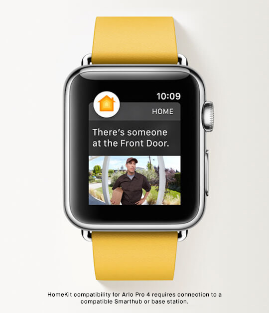 Person wearing Apple watch on wrist displaying Arlo motion alert