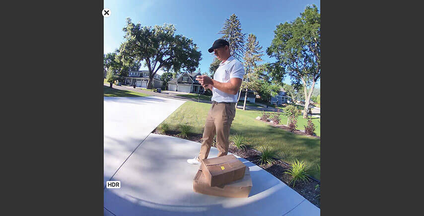 Smart phone displaying 2K HDR video displaying moving objects during the day