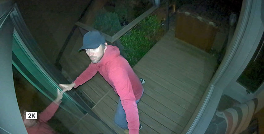 Smart phone displaying person caught on camera with camera colour night vision